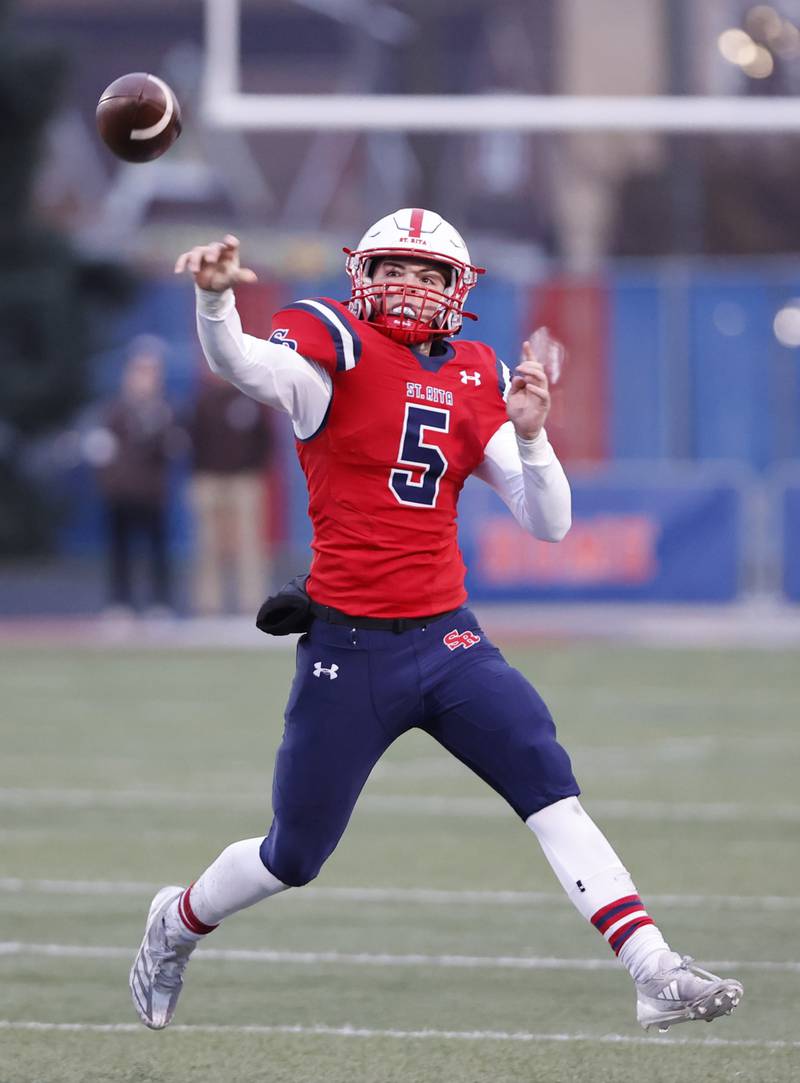 St. Rita's Steven Armbruster (5) scrambles and  throws during the class 7A semi-final playoff game between Mt. Carmel and St. Rita high schools on Saturday, Nov. 23, 2024 in Chicago.