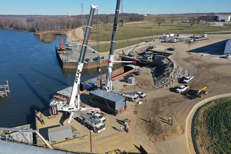 A crew from Atlas Crane Services hoist a 300,000 pound boiler made by the Cleaver-Brooks company in Lincoln Neb. on Wednesday Dec. 13, 2023 at Marquis Energy in Hennepin.. The boiler was transported by barge to to Hennepin from Nebraska using the Missouri River, Mississippi River and Illinois River. Marquis Energy is expected to receive several boilers within the next 12 months.