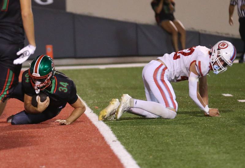 L-P's Easton Moriarty rolls in to score a touchdown over Ottawa's Joey Liebhart on Friday, Oct. 3, 2025 at Howard Fellows Stadium.