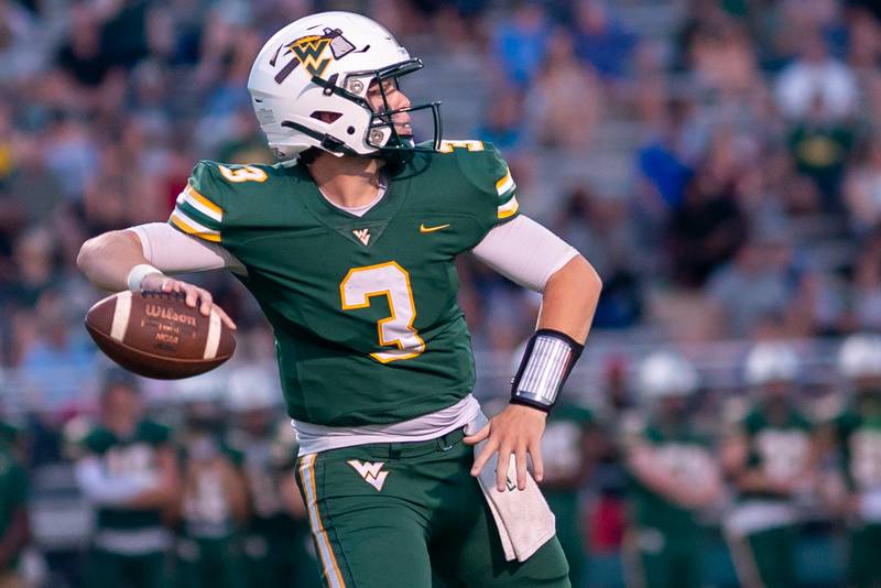 Waubonsie Valley's Luke Elsea (3) drops back in the pocket and looks downfield against Oswego East during a football game at Waubonsie Valley High School in Aurora on Friday, Aug. 25, 2023.