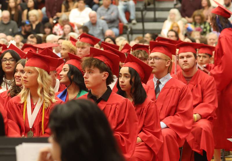 Ottawa High School Class of 2026 graduates watch other classmates receive their diplomas during the commencement ceremony in Kingman Gymnasium on Friday, May 22, 2026 at Ottawa High School