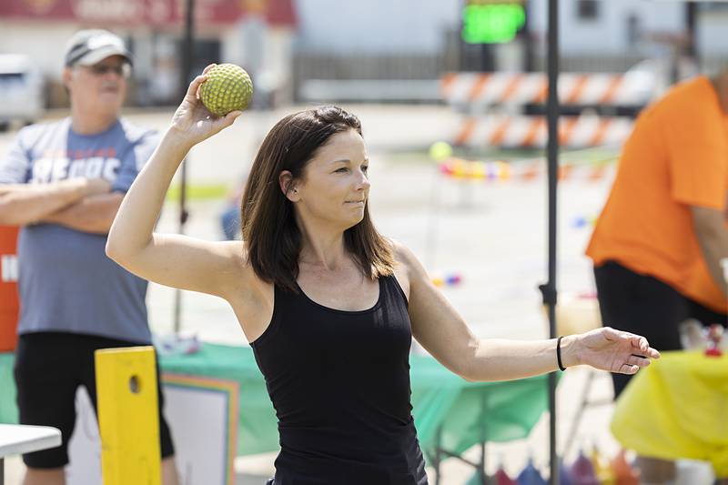 Jackie Pierceson loads up to fire a ball at the dunk tank where her step-son was the target Sunday, July 21, 2024 during Tampico Days.