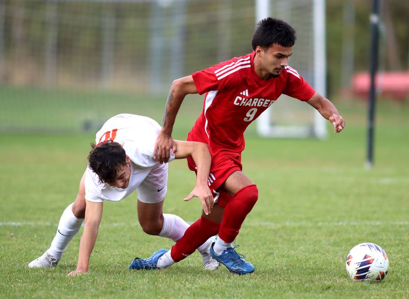 Dundee-Crown’s Guadalupe Martinez, right, races St. Charles East’s Huxley Kapoor for the ball in IHSA Class 3A Regional Championship soccer at Dundee-Crown High School in Carpentersville on Saturday, October 25, 2025.