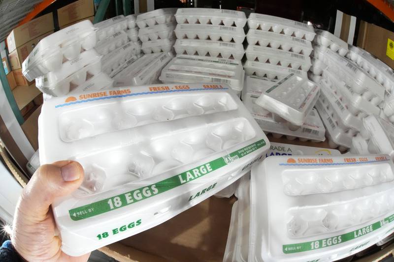 FILE - A shopper selects a carton of 18 Large Grade A eggs from a cooler in a Costco Warehouse in Cranberry, Pa., Jan. 28, 2025. (AP Photo/Gene J. Puskar, File)