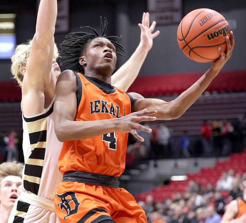 DeKalb's Johnny Henderson gets to the basket ahead of Sycamore's Burke Gautcher during the First National Challenge Friday, Jan. 27, 2023, at The Convocation Center on the campus of Northern Illinois University in DeKalb.