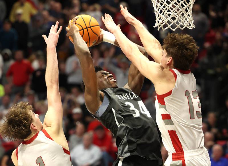 Kaneland's Jeffrey Hassan shoots over Morton's Silas Steffen for the game winning basket with one second left on the clock Monday, March 9, 2026, during their IHSA Class 3A supersectional matchup in the Convocation Center at Northern Illinois University in DeKalb.