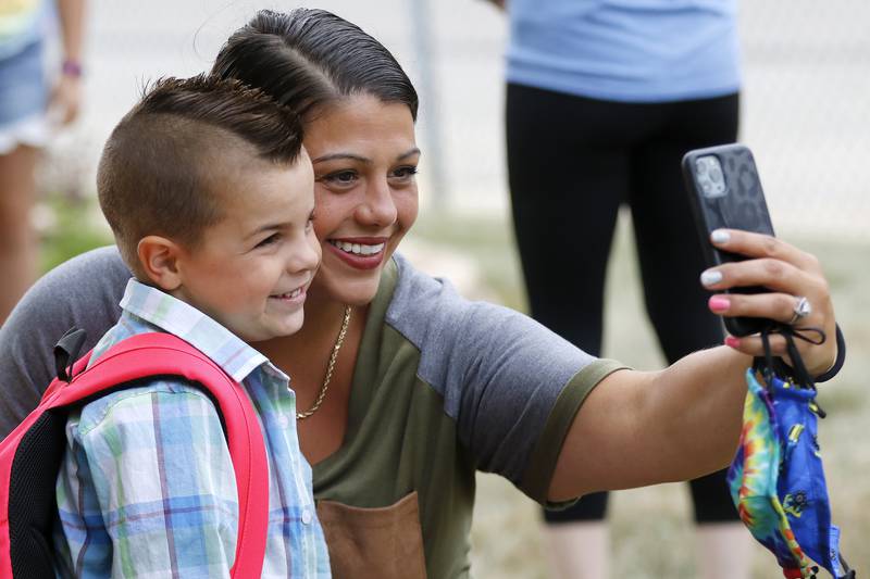 Heather Medinger and son Anthony, 5, pose for a selfie on the first day back at Landmark Elementary School on Wednesday, July 21, 2021, in McHenry.  The school, which has about 210 students, offers a shortened summer break but extended fall and winter breaks to make the educational process more year-round.