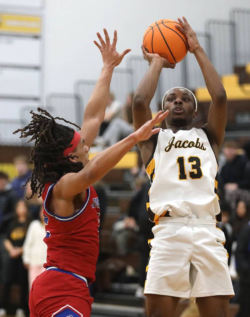 Jacobs' Elijah Bell shoots the ball over Dundee-Crown's Anthony Spain during a Fox Valley Conference boys basketball game on Tuesday, February. 3, 2026, at Jacobs High School in Algonquin.