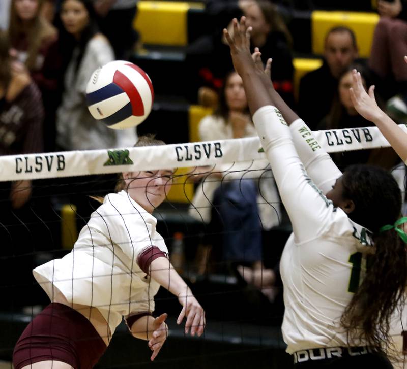 Prairie Ridge's Adeline Grider hits the ball past Crystal Lake South's Sahara Okiria during the IHSA Class 3A Crystal Lake South Sectional final volleyball match on Thursday, Nov. 7, 2024, at Crystal Lake South High School.