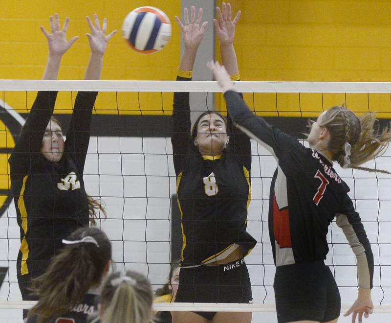 Putnam County blockers Maggie Spratt and Ava Hatton elevate against Woodland attacker Cloee Johnston (7) in Granville on Thursday, Aug. 25, 2022.