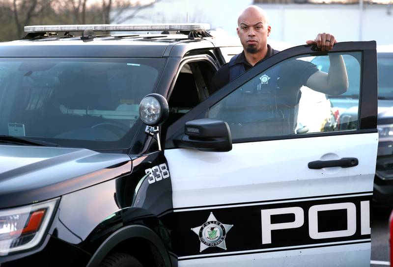 DeKalb Police Officer Justin Hickman by a patrol vehicle Friday, April 19, 2024, outside the DeKalb Police Department.