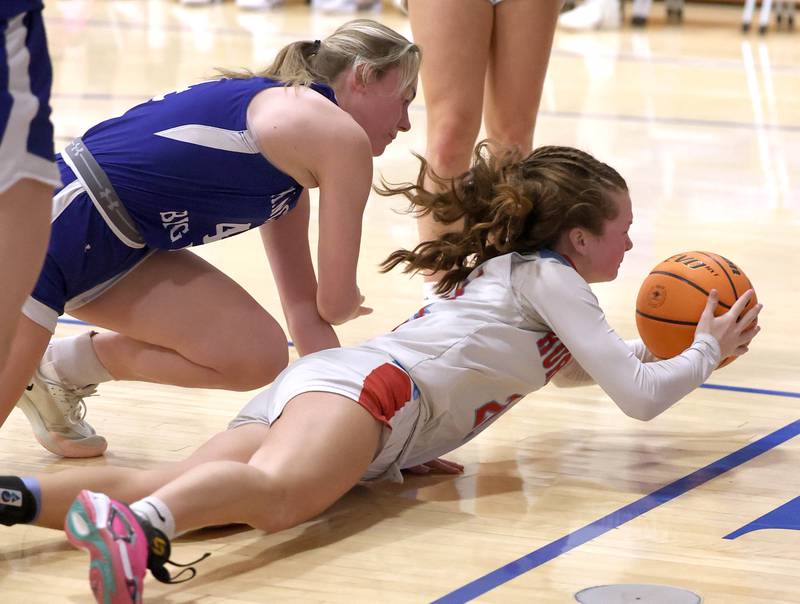 Marian Central's Lainey Remke dives for a loose ball in front of Hinckley-Big Rock's Anna Herrmann Monday, Feb. 16, 2026, during their regional semifinal game at Hinckley-Big Rock High School.
