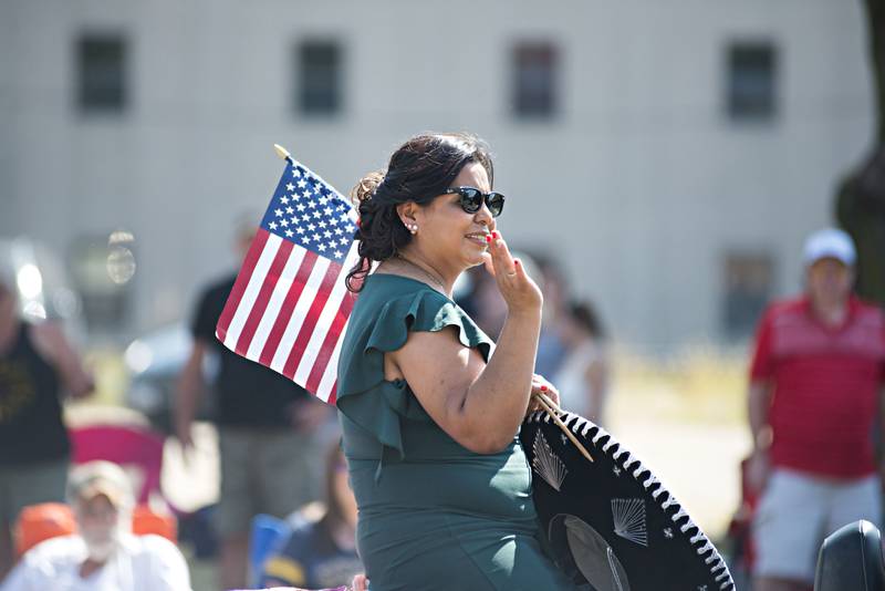 Raquel Sifuentes, the 2021 grand marshal of the Fiesta Parade, waves to the crowd Saturday, Sep. 19, 2021, in Sterling. The 68th annual event started in Rock Falls and made its way over the bridge.