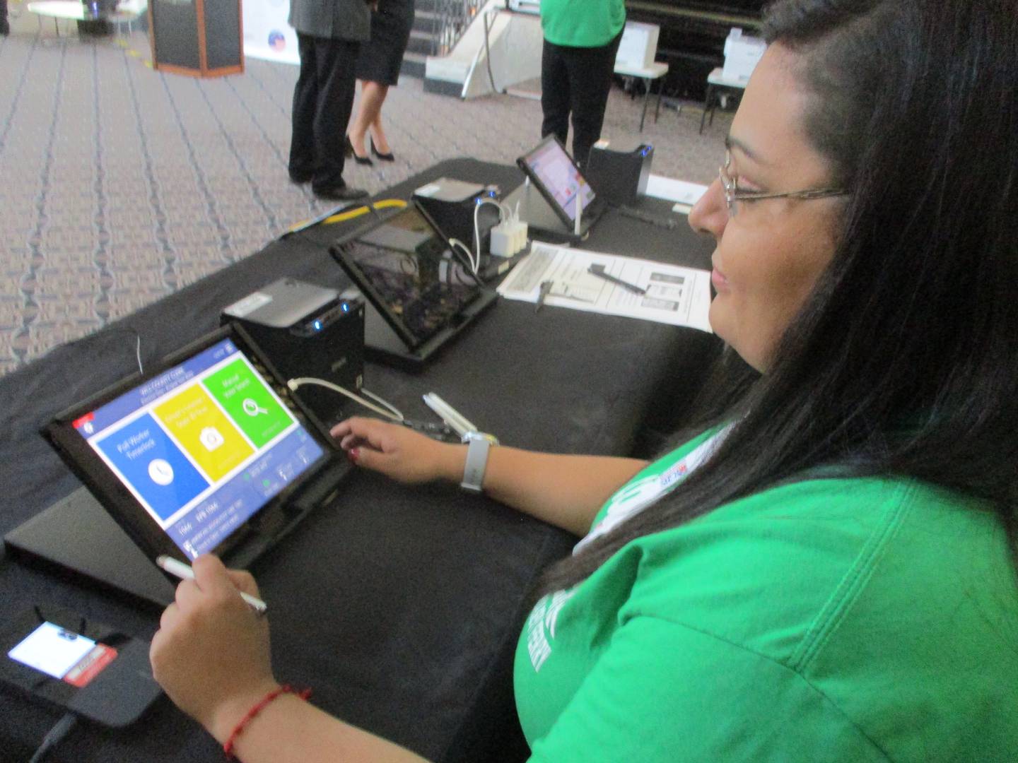 Tanya Arias, election analyst with the Will County Clerk's Office, demonstrates the new poll book that election judges will use during an exhibit of new election equipment at the Renaissance Center in Joliet on Friday, Dec. 15, 2023.