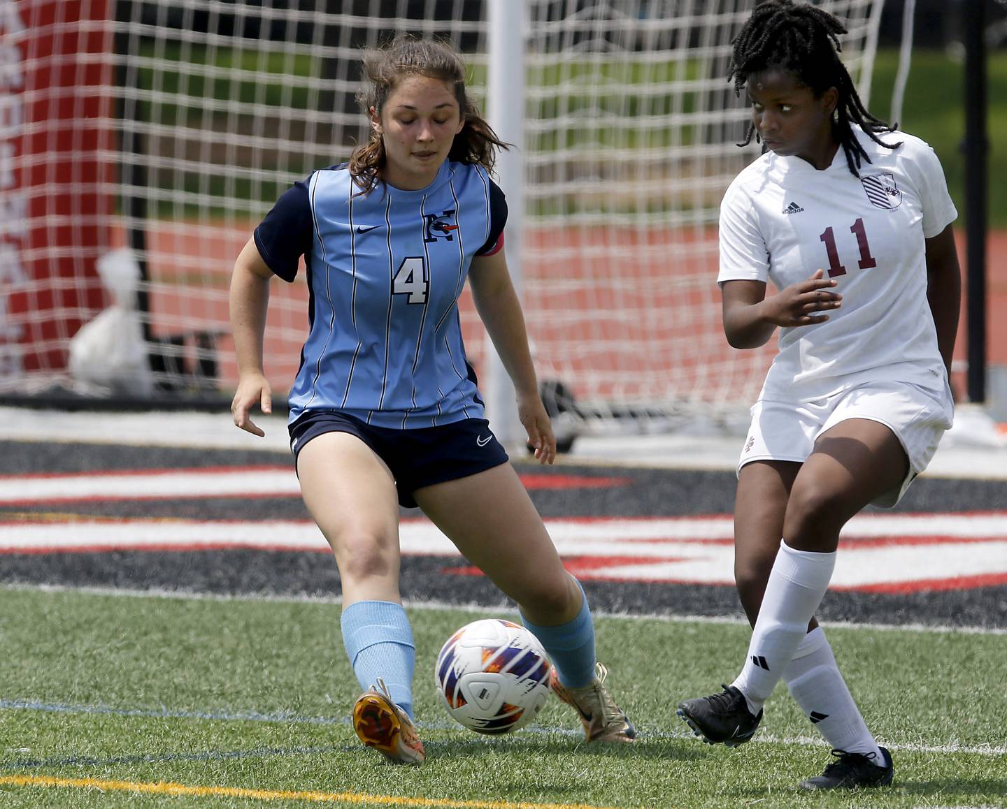 Nazareth Academy's Izzy Strnic tries to defend St. Ignatius College Prep's Kayla Washington during a IHSA Class 2A State Girls Soccer semifinal match on Friday, June 6, 2025, at North Central College in Naperville.