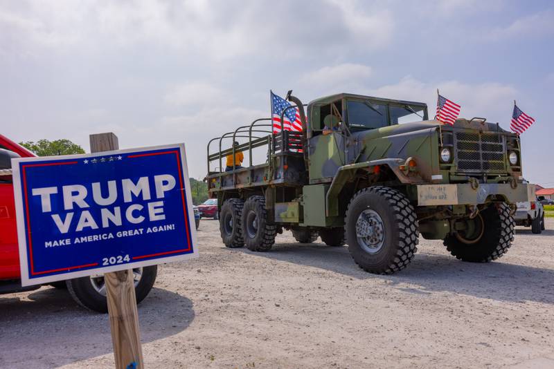 An M35 Military Cargo truck that participated in the caravan leaves Jamie's Outpost at the start of the Trump Birthday and Flag Day Caravan and Rally on June 14, 2025 in Utica.