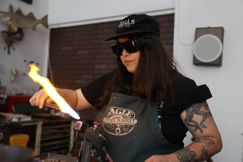 Angelica Cristal works on a glass pendent at her shop. Angelica is opening her own glass art business in the former Regis Glass Art Space in Downtown Joliet.