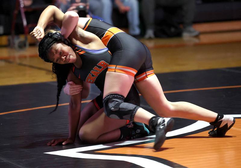 Kaneland’s Bella Gruber (top)  turns DeKalb’s Kayden Johnson during their 130 pound match Wednesday, Jan. 7, 2026, at DeKalb High School.