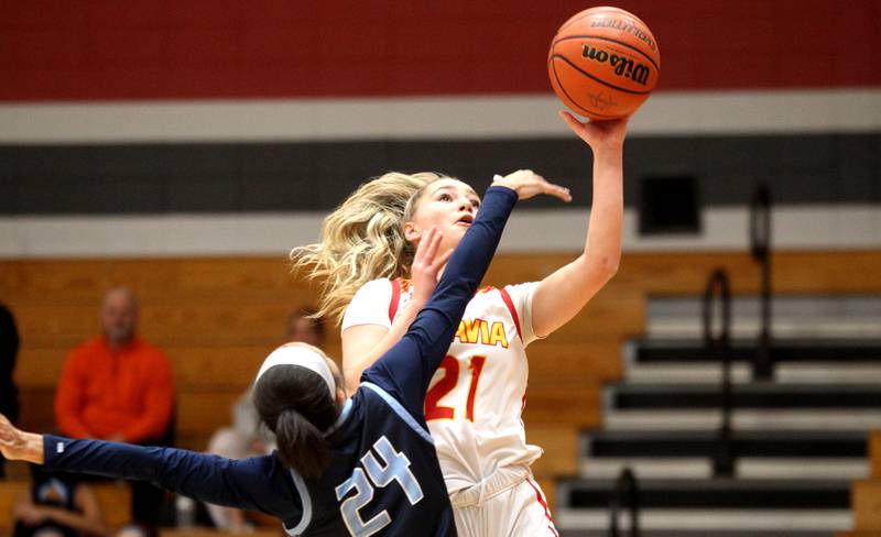 Batavia’s Kylee Gehrt (21) puts up a shot over Lake Park’s Gabi Burgess (24) during a home game against Lake Park on Tuesday, Dec. 6, 2022.