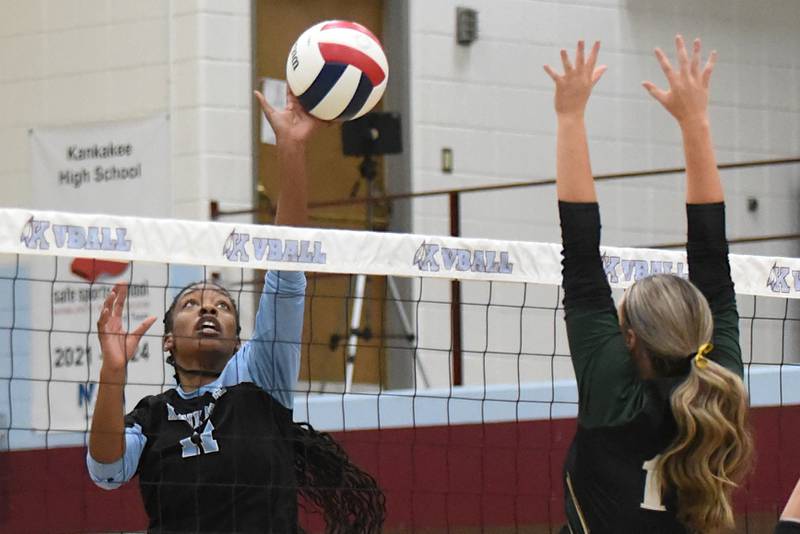 Kankakee's Shania Johnson, left, looks to send a hit past Bishop McNamara's Kate Dole during an All-City game at Kankakee Wednesday, Sept. 3, 2025.