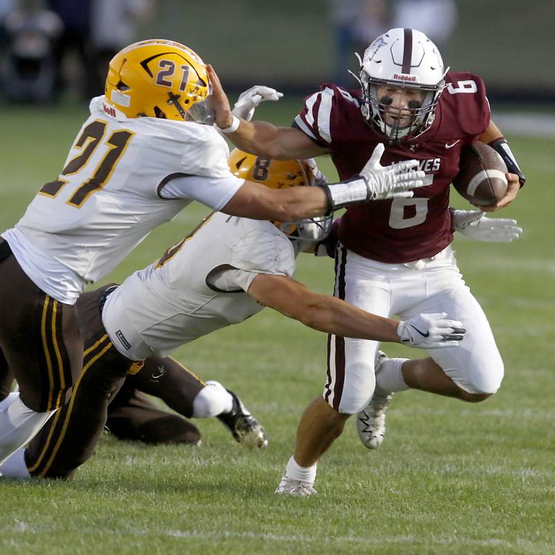 Prairie Ridge's Luke Vanderwiel (right) stiff arms Jacobs' Nick Meyer (left) as Meyer and Jacobs' Brandon Chvatal tackle Vanderwiel during a Fox Valley Conference football game on Friday, Sept. 5, 2025, at Prairie Ridge High School in Crystal Lake.