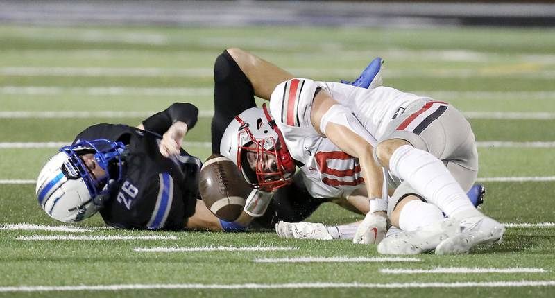 Palatine's Connor May (10) and St. Charles North's Aidan McClure (26) collide after a dropped pass Friday August 25, 2023 in St. Charles.