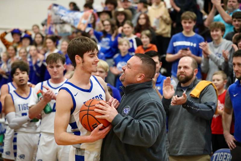 Princeton coach Jason Smith congratulates PHS senior Grady Thompson after setting the PHS boys all-time scoring record Tuesday night at Prouty Gym. He overtook Tiger legend, Joe Ruklick, who held the record at 1,306 for 68 years.