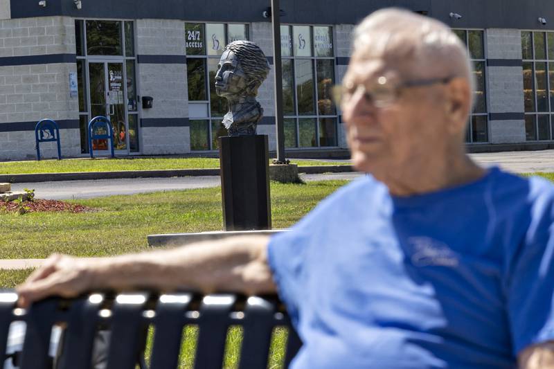Mel Jackley of Sterling takes a rest while “Grace” by David Zahn is displayed Saturday, August 23, 2025, in Rock Falls.