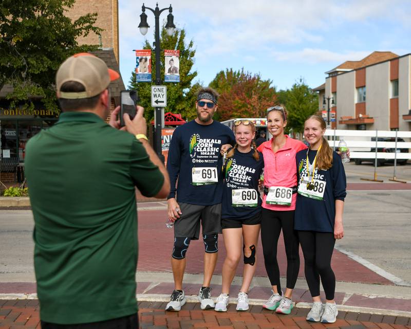 The Puls family pose for a photo after finishing the DeKalb Corn Classic 5K/10K race on Sunday, Sept. 29, 2024, which traveled through downtown DeKalb.
