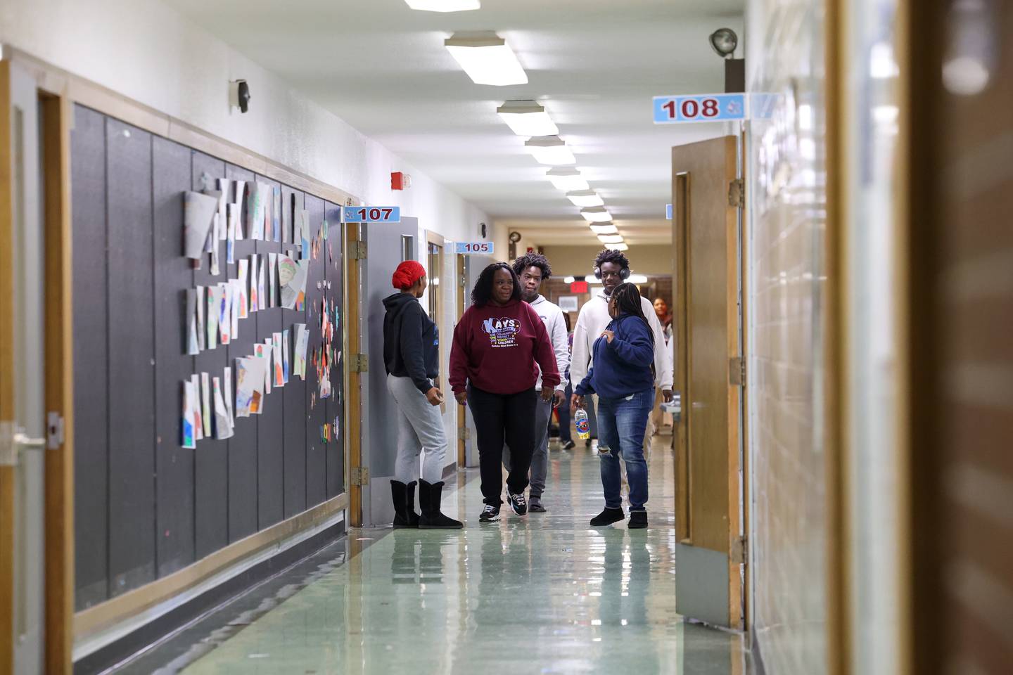 Kindergarten teacher Frances Noble, center, walks the hall with two of her former students, rear, at Edison Primary School in Kankakee on Jan. 7, 2026, as she packed up her classroom following the school's emergency closure by Kankakee School District 111.
