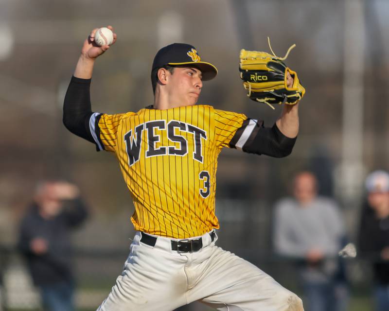 Joliet West's Juan Rico (3) winds up to throw a pitch during varsity baseball game between Oswego East at Joliet West.  April 10, 2023.