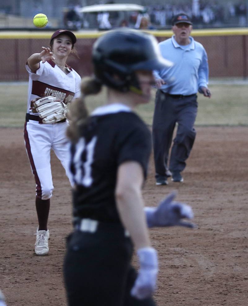 Richmond-Burton’s Jocelyn Hird shows to first base as Prairie Ridge's Kendra Carroll legs out a hit during a nonconference softball game  on Tuesday, March 18, 2025, at Richmond-Burton High School.
