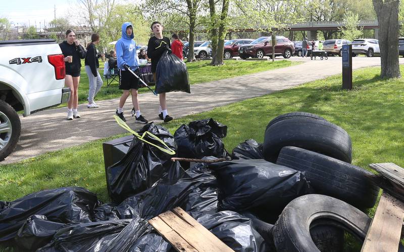 Keegan Campbell and Monty Moats collect trash during the Perfectly Flawed Foundation cleanup on Saturday, April 26, 2025 near the Lock 14 shelter on the Illinois & Michigan Canal in La Salle.