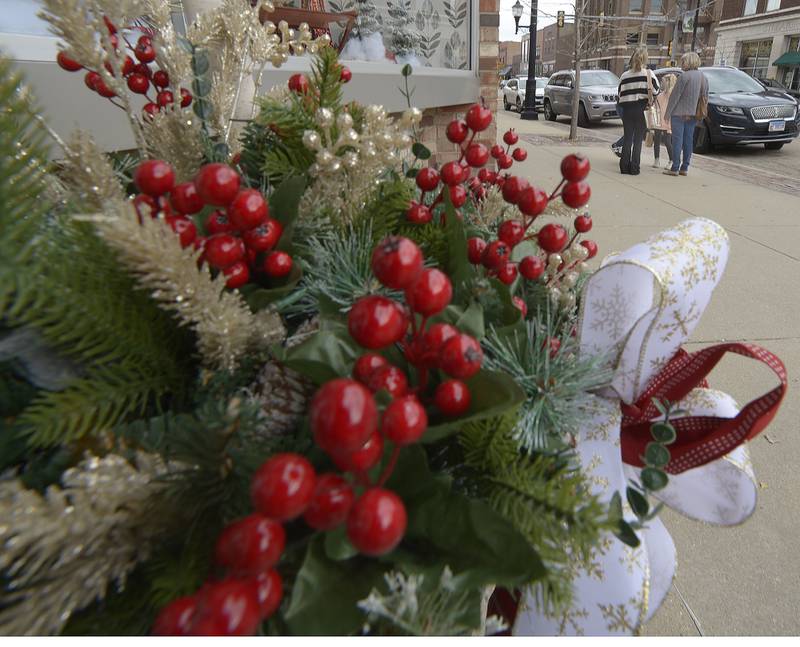Shoppers meet and talk along Main St, during Streator’s Mistletoe Market Saturday .