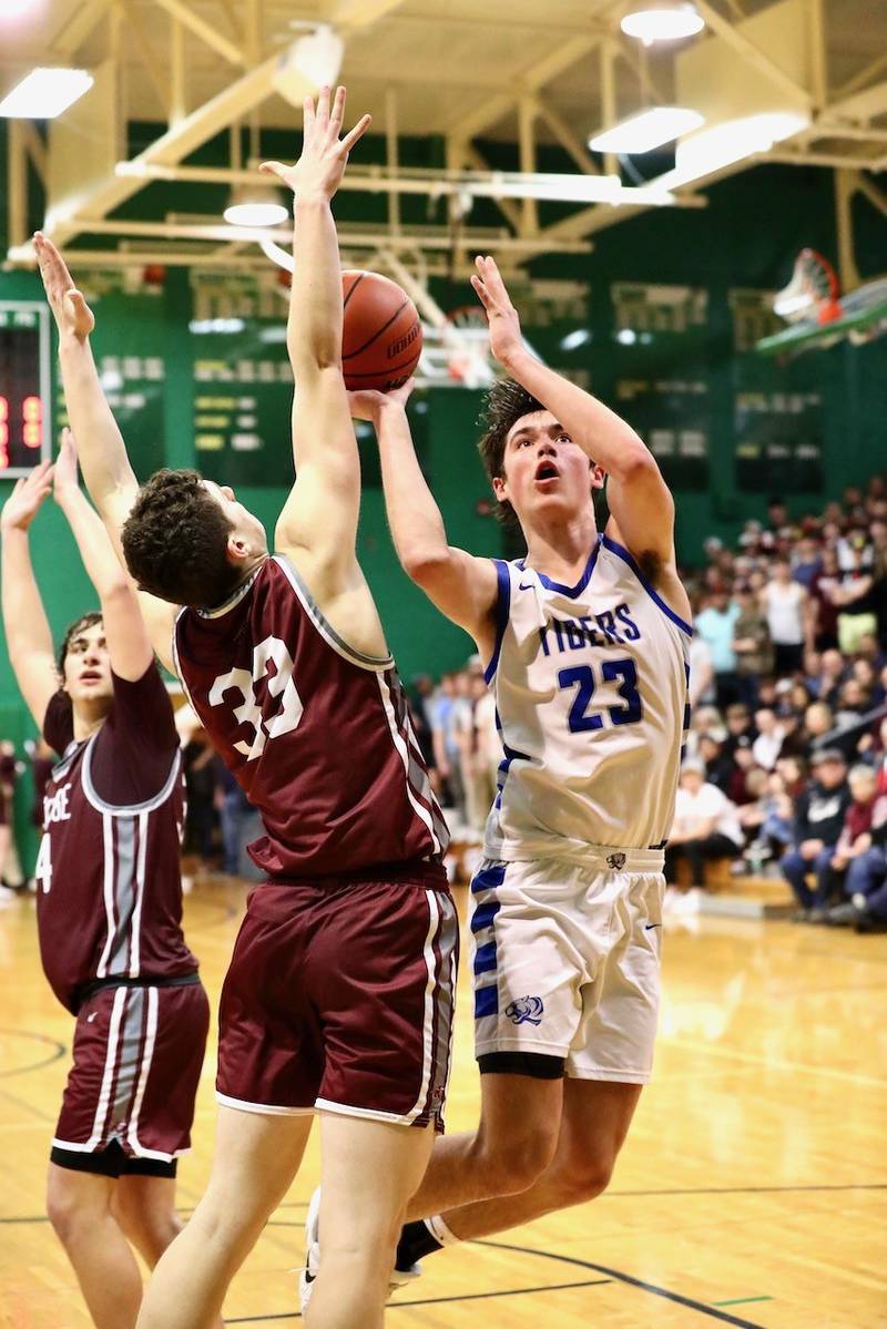 Princeton sophomore Noah LaPorte shoots over Rockridge's Tj Wilson in Friday's Class 2A Orion Sectional at Geneseo.