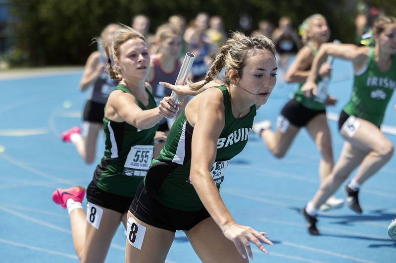 St. Bede’s Anna Lopez (right) reaches back for the baton from Rubi De La Torre in the 4x100 race Saturday, May 20, 2023 during the IHSA state track and field finals at Eastern Illinois University in Charleston.