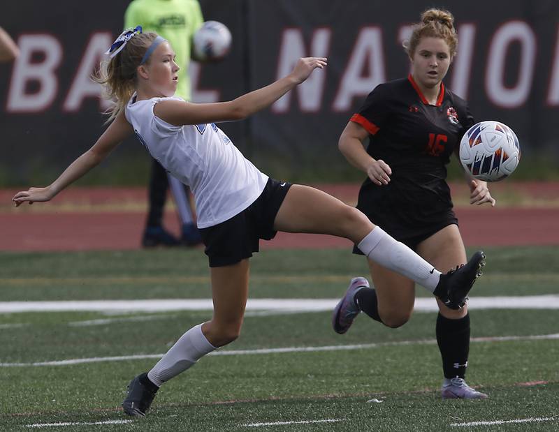 Lincoln-Way East's Kara Waishwell kicks tre ball in front or Libertyville’s Shea Krakowski during the IHSA Class 3A state third-place match at North Central College in Naperville on Saturday, June 3, 2023.