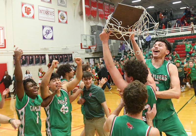 (From left) L-P's Cordel Wheatley, Andy Medina, Marion Persich, Jackson Sellett, Mikey Hartman and Erick Sotelo hoist the Class 3A Regional title plaque after defeating Streator on Friday, Feb. 28, 2025 in Sellett Gymnasium at L-P High School.