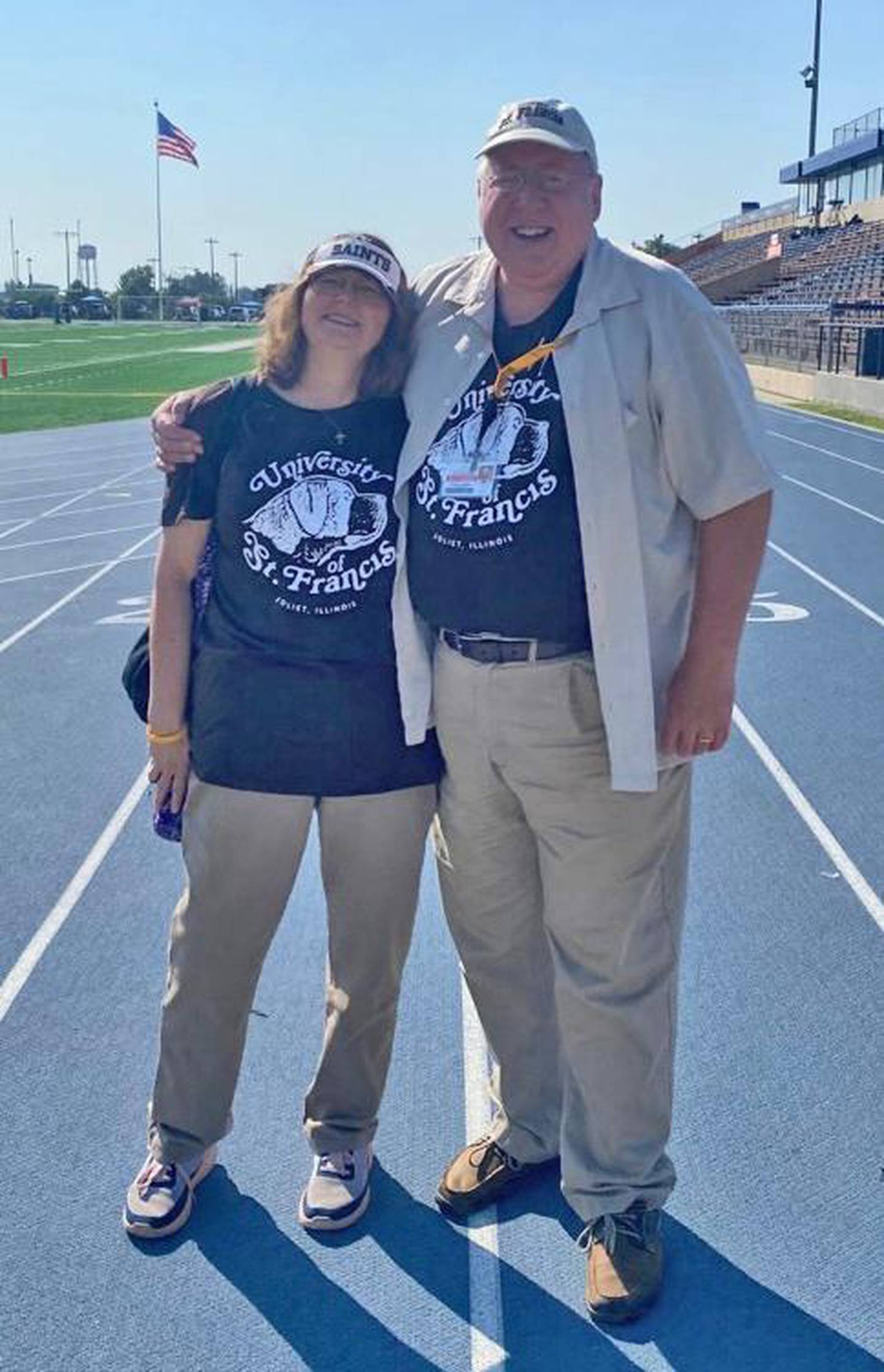 University of st. Francis President Arvid C. Johnson is seen with his wife, Anne as they cheer on the Fighting Saints at USF’s 2023 homecoming celebration. On Monday, the University of St. Francis Board of Trustees announced Johnson's retirement on May 31, 2025.