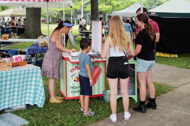 A family buys popsicles from Ms. Mint’s Pop Shop Saturday, July 1, 2023 at Nuts About Art in Dixon.