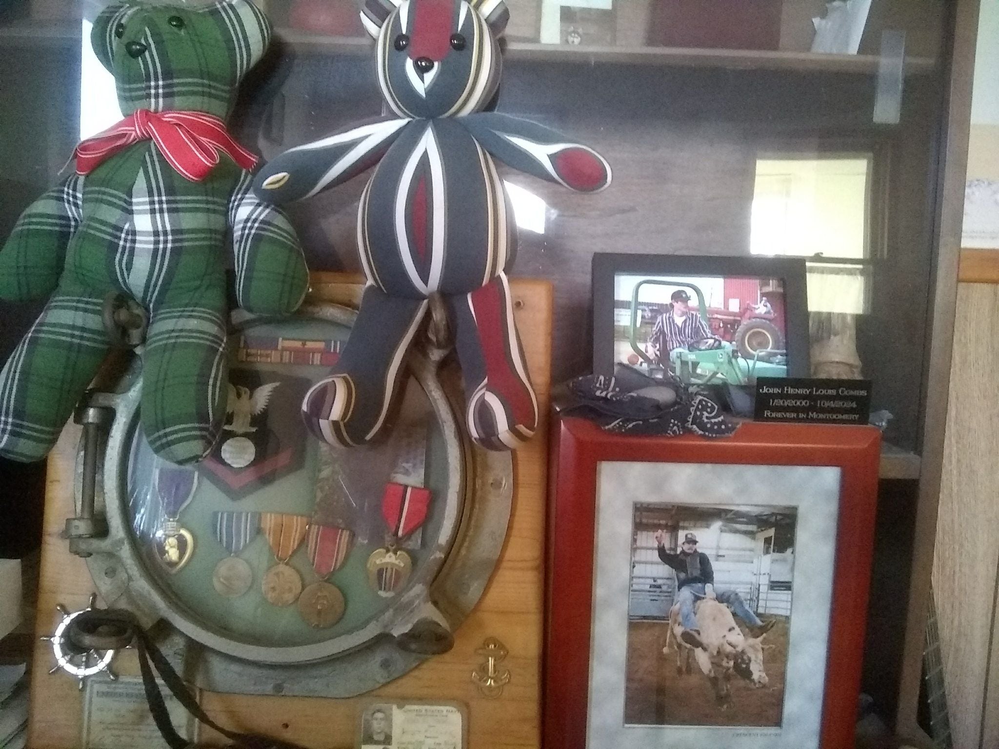 Chris Combs has a commemorative area at his home displaying his grandfather's Navy porthole along with his medals. He's also had bears made from shirts that belonged to his grandfather and his late son, John.