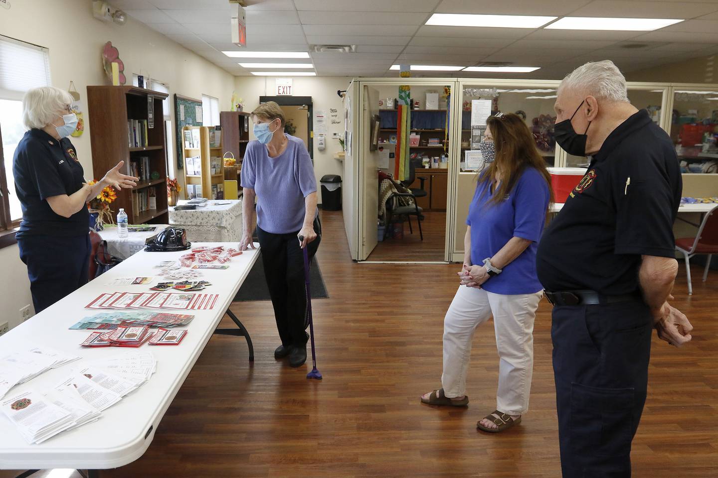 Retired McHenry Township Fire Protection District members Judy Robel, left, and husband Al Robel, right, talk with first-time blood donor Kathie Abendroth, of McHenry, and Senior Services Associates Activities Director Jane Gregory during the Meet a Hero Be a Hero blood drive with AmeriCorps Seniors, Senior Service Associates, and Versiti at McHenry Senior Center on Thursday, Sept. 9, 2021 in McHenry.  The blood drive booked all 24 appointments and offered donors a chance to meet some first responders from the Johnsburg Police Department and McHenry Township Fire Protection District as a rememberance on the 20th anniversary of the terrorism attacks on Sept. 11, 2001.