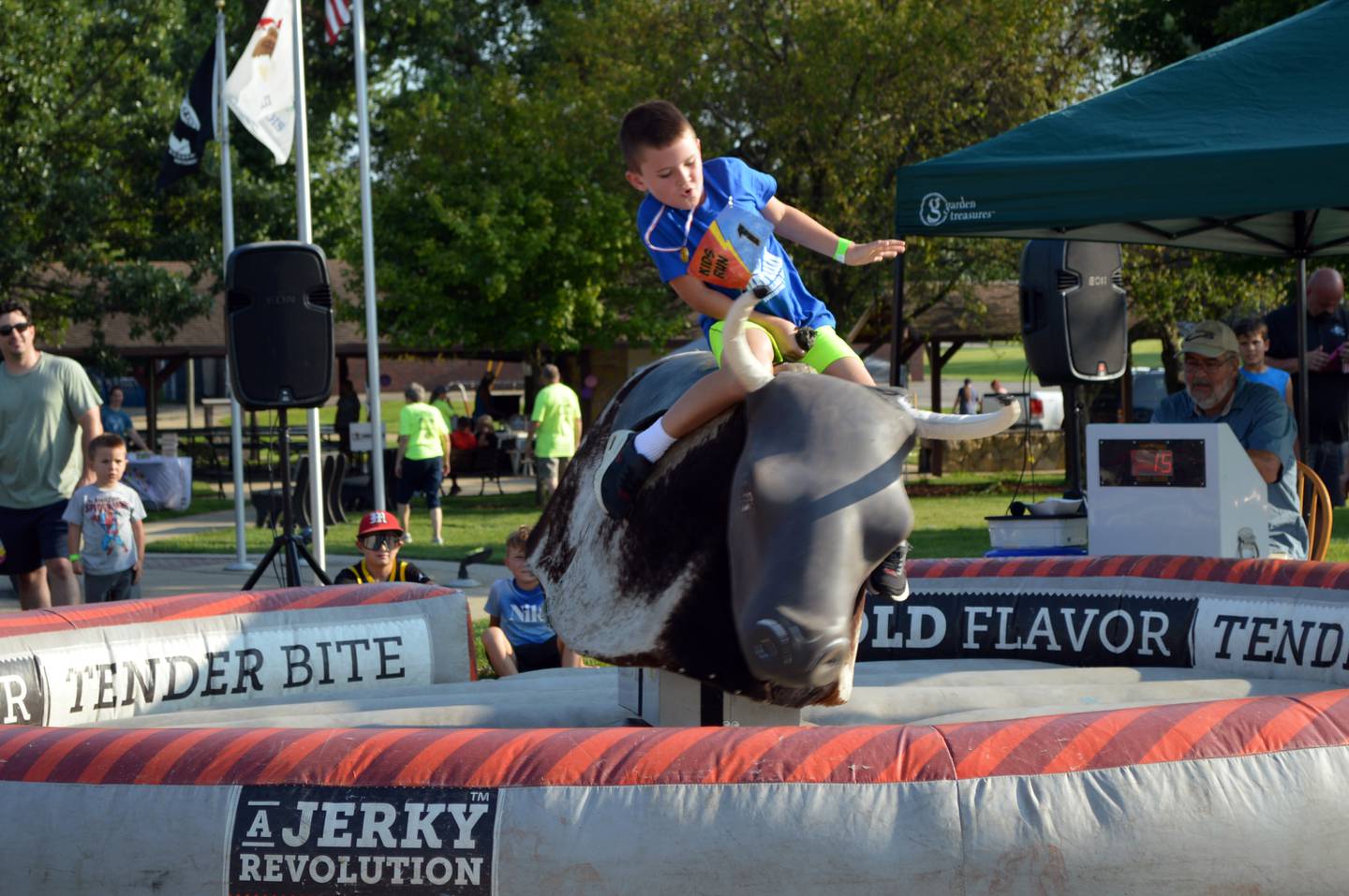 Charlie Slick, 8, of Forreston, tries to stay astride a mechanical bull on Friday, Aug. 2, 2024, during Forreston Sauerkraut Days.