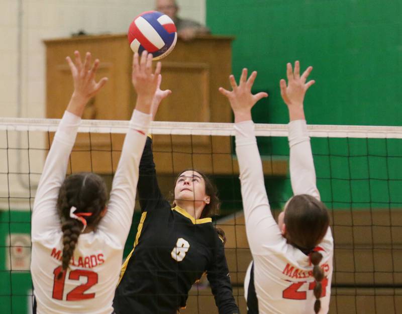 Putnam County's Ava Hatton (8) sends a spike past Henry's Kaitlyn Anderson (12) and teammate Harper Schrock (24) in the Tri-County Conference Tournament on Monday, Oct. 10, 2022 in Seneca.