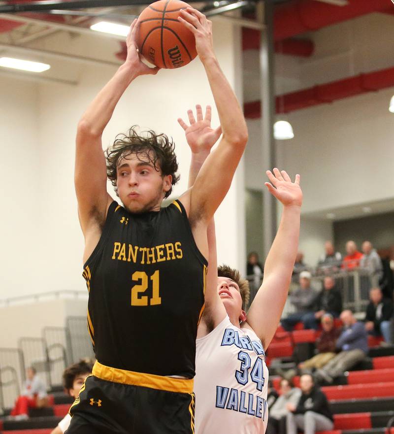 Putnam County's Orlando Harris grabs a rebound over Bureau Valley's Jon Dybeck during the 49th annual Colmone Class on Thursday, Dec. 7, 2023 at Hall High School.