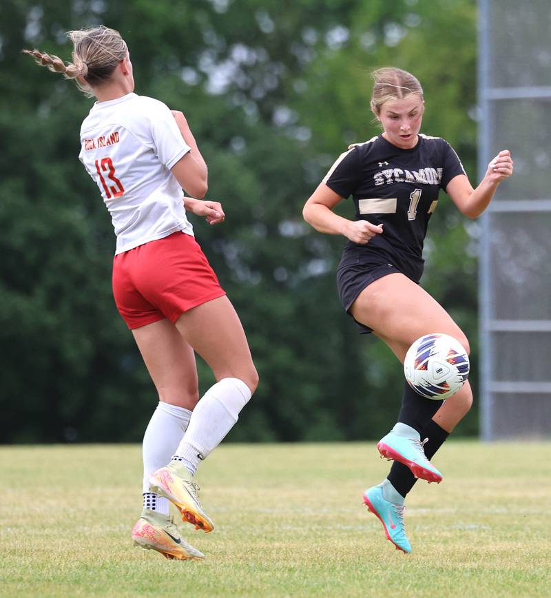 Sycamore's Elizabeth Goff tries to get the ball by Rock Island's Izzy Spurgetis Friday, May 22, 2026, during their Class 2A regional championship matchup at Sycamore High School.