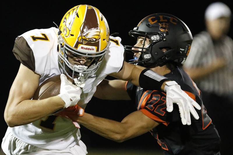 Jacobs' Grant Stec, left, is hit by Crystal Lake Central's Vince Honer  during their week 2 football game on Friday, Sep. 3, 2021 at Crystal Lake Central High School in Crystal Lake.