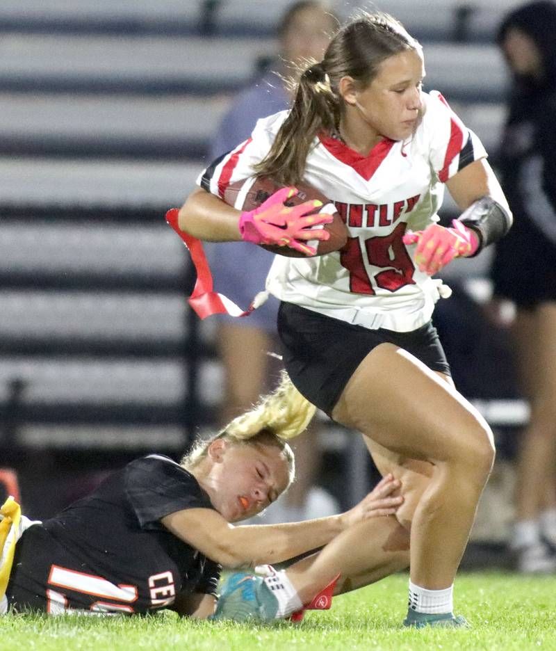 Huntley’s Mya Ouimette, right, runs the ball past Crystal Lake Central’s Mae Anderson in varsity flag football at Owen Metcalf Field on the campus of Crystal Lake Central High School in Crystal Lake on Tuesday, Sept. 16, 2025.