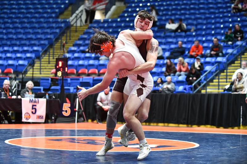 Issac Clauson of Joliet Catholic Academy takes down Connor Moga of Hersey in the 175-pound match during the IHSA Dual Team State Finals in Bloomington on Saturday, March 1.