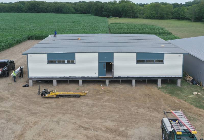 Crews install four 70 x 70 modular classrooms on the new property next to Waltham School on Monday, July 8, 2024 in Utica. The school, built in 2018, has already outgrown its 240 student capacity and placed the four classrooms next to the school.